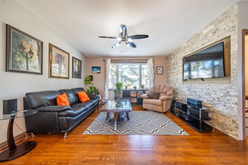 4604 Namaka Crescent Nw, Calgary, AB - Indoor Photo Showing Living Room With Fireplace