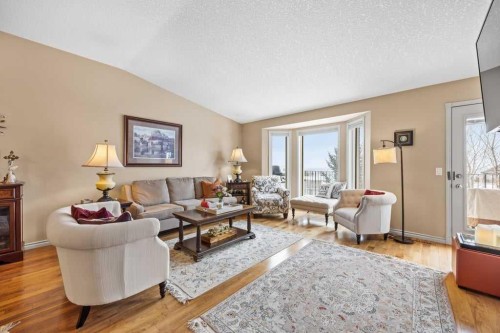 4 Prominence Path Sw, Calgary, AB - Indoor Photo Showing Living Room With Fireplace