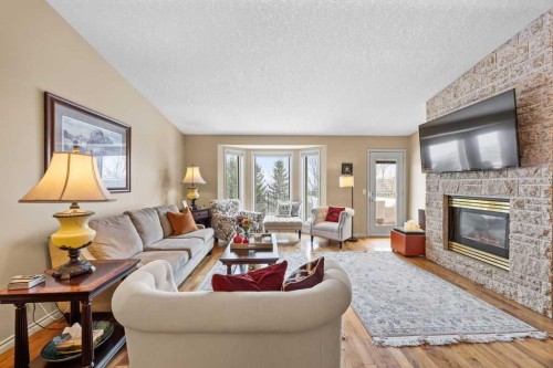 4 Prominence Path Sw, Calgary, AB - Indoor Photo Showing Living Room With Fireplace