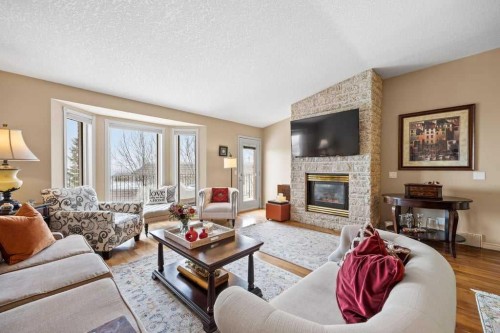 4 Prominence Path Sw, Calgary, AB - Indoor Photo Showing Living Room With Fireplace