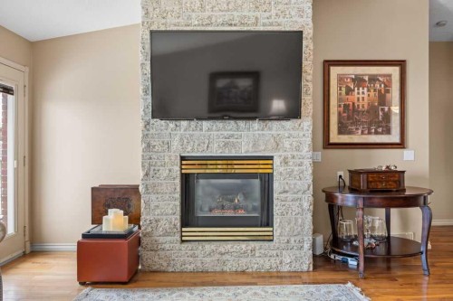4 Prominence Path Sw, Calgary, AB - Indoor Photo Showing Living Room With Fireplace