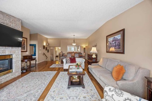 4 Prominence Path Sw, Calgary, AB - Indoor Photo Showing Living Room With Fireplace
