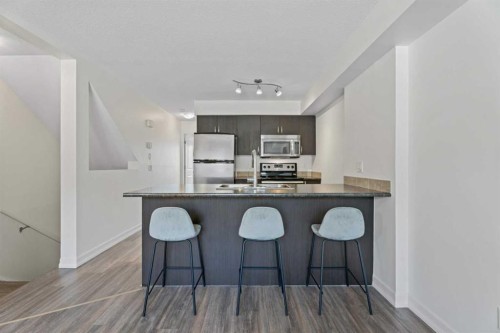 410-121 Copperpond Common Se, Calgary, AB - Indoor Photo Showing Kitchen With Stainless Steel Kitchen With Upgraded Kitchen