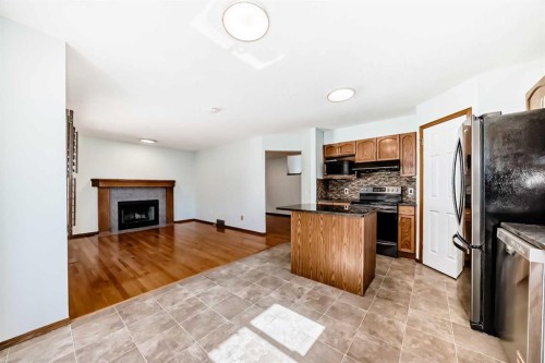 164 Macewan Park Circle Nw, Calgary, AB - Indoor Photo Showing Kitchen With Fireplace