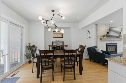 40 Grafton Crescent Sw, Calgary, AB - Indoor Photo Showing Dining Room With Fireplace