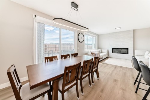 80 Vantage Drive, Cochrane, AB - Indoor Photo Showing Dining Room With Fireplace
