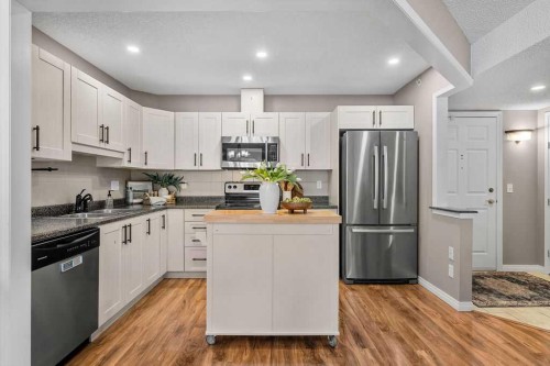1311-1311 Hawksbrow Point Nw, Calgary, AB - Indoor Photo Showing Kitchen With Stainless Steel Kitchen With Double Sink With Upgraded Kitchen