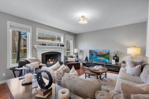 52 West Coach Court Sw, Calgary, AB - Indoor Photo Showing Living Room With Fireplace