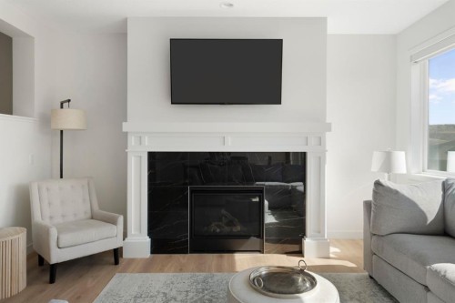 164 Precedence Hill, Cochrane, AB - Indoor Photo Showing Living Room With Fireplace