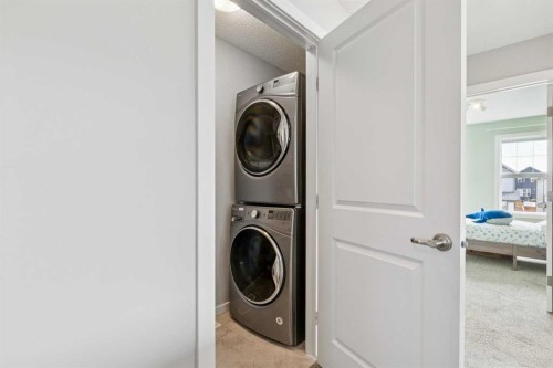 99 Heritage Heights, Cochrane, AB - Indoor Photo Showing Laundry Room