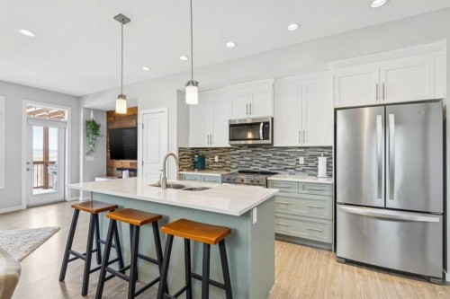 99 Heritage Heights, Cochrane, AB - Indoor Photo Showing Kitchen With Double Sink With Upgraded Kitchen