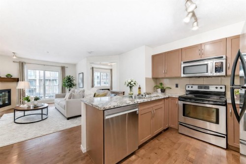 4305-115 Prestwick Villas Se, Calgary, AB - Indoor Photo Showing Kitchen With Fireplace With Stainless Steel Kitchen With Double Sink