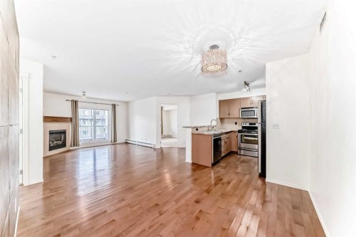 4305-115 Prestwick Villas Se, Calgary, AB - Indoor Photo Showing Kitchen With Fireplace