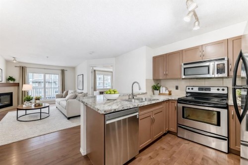 4305-115 Prestwick Villas Se, Calgary, AB - Indoor Photo Showing Kitchen With Fireplace With Stainless Steel Kitchen With Upgraded Kitchen