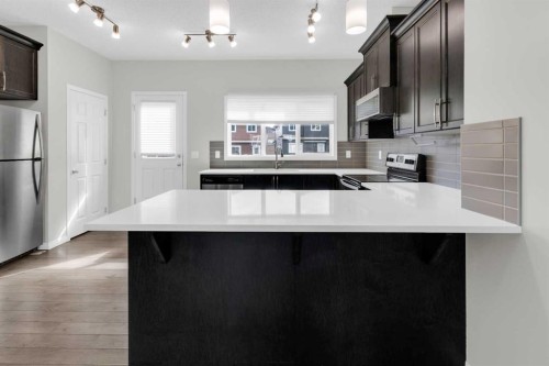 140 Sundown Road, Cochrane, AB - Indoor Photo Showing Kitchen With Upgraded Kitchen