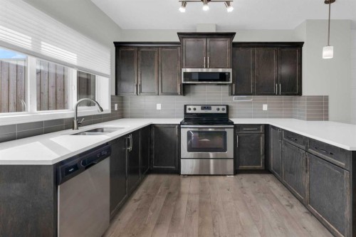 140 Sundown Road, Cochrane, AB - Indoor Photo Showing Kitchen With Double Sink With Upgraded Kitchen