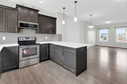 140 Sundown Road, Cochrane, AB - Indoor Photo Showing Kitchen With Upgraded Kitchen