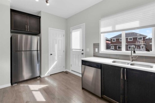 140 Sundown Road, Cochrane, AB - Indoor Photo Showing Kitchen With Double Sink