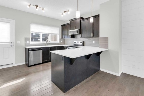 140 Sundown Road, Cochrane, AB - Indoor Photo Showing Kitchen With Upgraded Kitchen