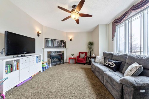 4 Cimarron Trail, Okotoks, AB - Indoor Photo Showing Living Room With Fireplace
