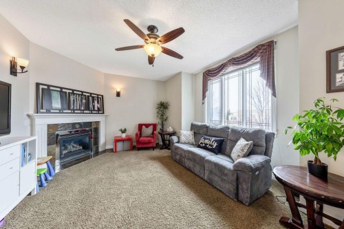 4 Cimarron Trail, Okotoks, AB - Indoor Photo Showing Living Room With Fireplace