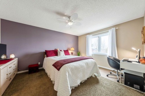 4 Cimarron Trail, Okotoks, AB - Indoor Photo Showing Bedroom