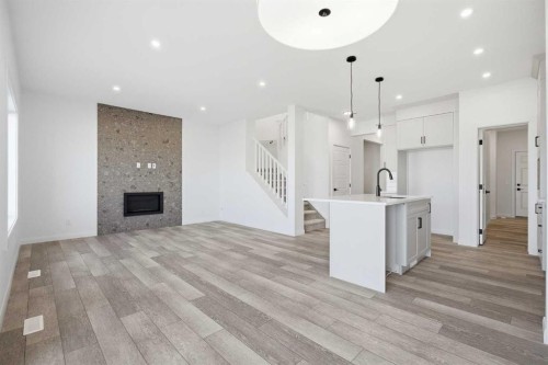 260 Dawson Wharf Crescent, Chestermere, AB - Indoor Photo Showing Other Room With Fireplace