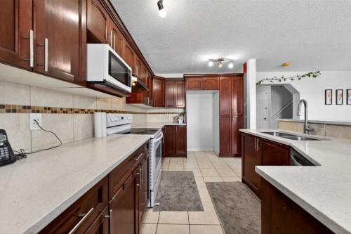 110 Martha'S Haven Green Ne, Calgary, AB - Indoor Photo Showing Kitchen With Double Sink