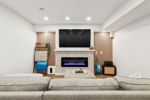 36 Crestbrook Link Sw, Calgary, AB - Indoor Photo Showing Basement With Fireplace