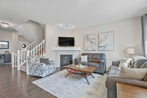 49 Kingsbridge Place Se, Airdrie, AB - Indoor Photo Showing Living Room With Fireplace