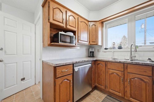 1012 Riddell Place Se, Calgary, AB - Indoor Photo Showing Kitchen With Double Sink