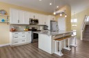 140 Emberside Glen, Cochrane, AB  - Indoor Photo Showing Kitchen With Stainless Steel Kitchen With Upgraded Kitchen 
