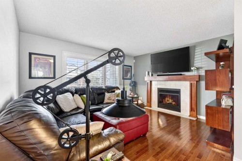 27 Copperpond Heights Se, Calgary, AB - Indoor Photo Showing Living Room With Fireplace