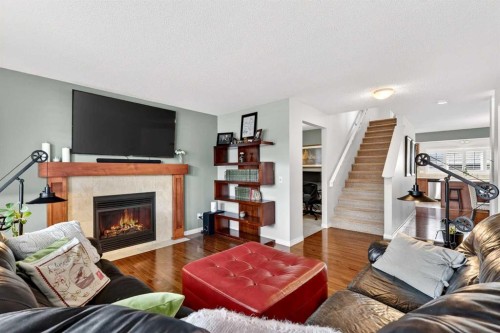 27 Copperpond Heights Se, Calgary, AB - Indoor Photo Showing Living Room With Fireplace