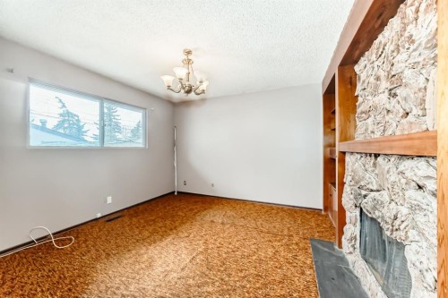 619 Maryvale Way Ne, Calgary, AB - Indoor Photo Showing Other Room With Fireplace