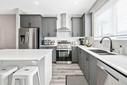 68 Wolf Gate, Okotoks, AB - Indoor Photo Showing Kitchen With Double Sink With Upgraded Kitchen