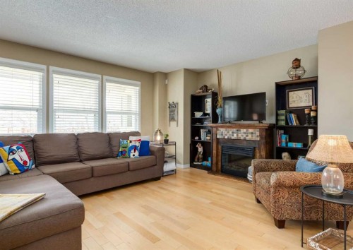 165 Walden Manor Se, Calgary, AB - Indoor Photo Showing Living Room With Fireplace