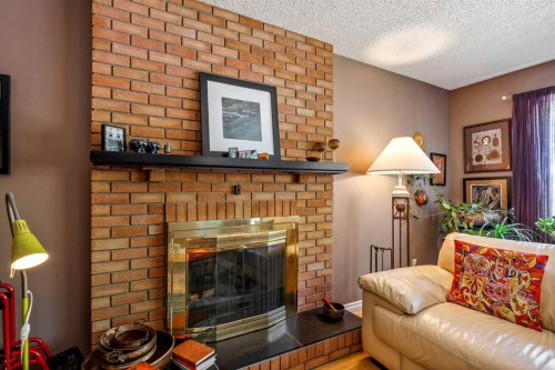 5 Fraser Road Se, Calgary, AB - Indoor Photo Showing Living Room With Fireplace