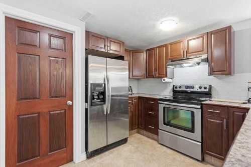 111 Shawglen Road Sw, Calgary, AB - Indoor Photo Showing Kitchen With Stainless Steel Kitchen