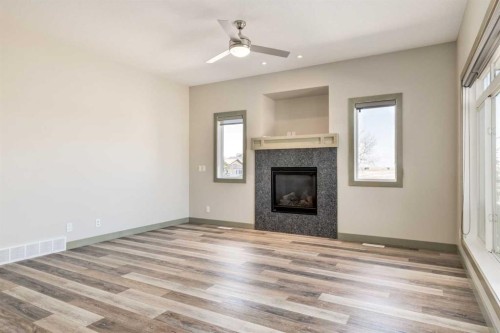 102 Speargrass Crescent, Carseland, AB - Indoor Photo Showing Other Room With Fireplace