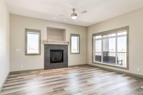 102 Speargrass Crescent, Carseland, AB - Indoor Photo Showing Living Room With Fireplace