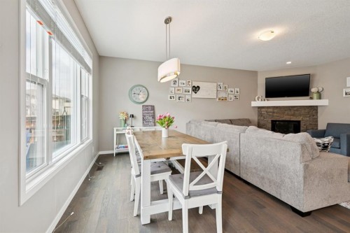 80 Brightoncrest Point Se, Calgary, AB - Indoor Photo Showing Dining Room With Fireplace
