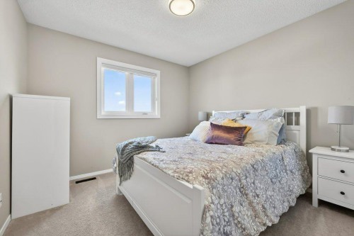 7 Henderson Bay Ne, Langdon, AB - Indoor Photo Showing Bedroom