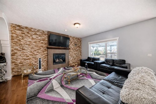 104 Panamount Terrace Nw, Calgary, AB - Indoor Photo Showing Living Room With Fireplace