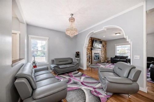 104 Panamount Terrace Nw, Calgary, AB - Indoor Photo Showing Living Room With Fireplace