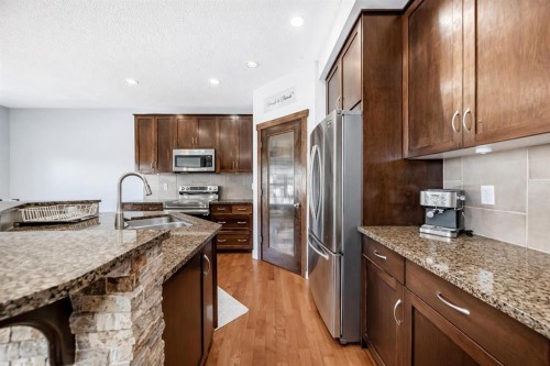 104 Panamount Terrace Nw, Calgary, AB - Indoor Photo Showing Kitchen With Stainless Steel Kitchen With Double Sink