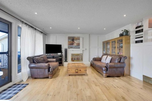 5819 Coach Hill Road Sw, Calgary, AB - Indoor Photo Showing Living Room With Fireplace