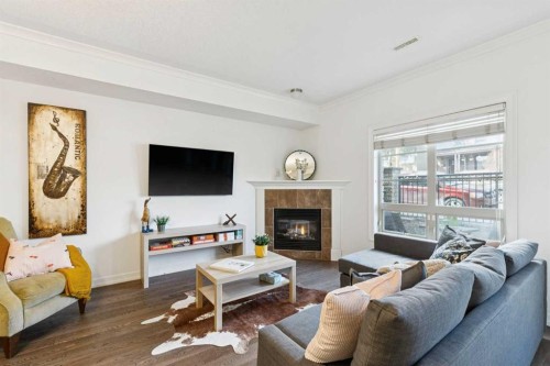 6-1729 34 Avenue Sw, Calgary, AB - Indoor Photo Showing Living Room With Fireplace