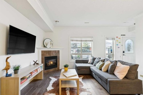 6-1729 34 Avenue Sw, Calgary, AB - Indoor Photo Showing Living Room With Fireplace
