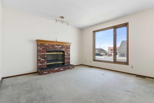 190 Hawkville Close Nw, Calgary, AB - Indoor Photo Showing Living Room With Fireplace
